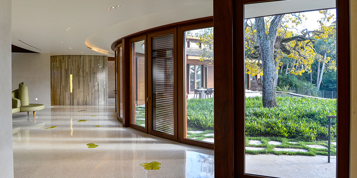 Throughout the terrazzo floor, translucent accents in the form of sea grape leaves are backlit with custom-shaped LED panels manufactured by DLC Lumisheet.