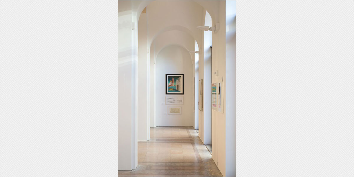  Gallery arcade with Solavanti Kera indirect sconces uplighting the vaulted ceiling.