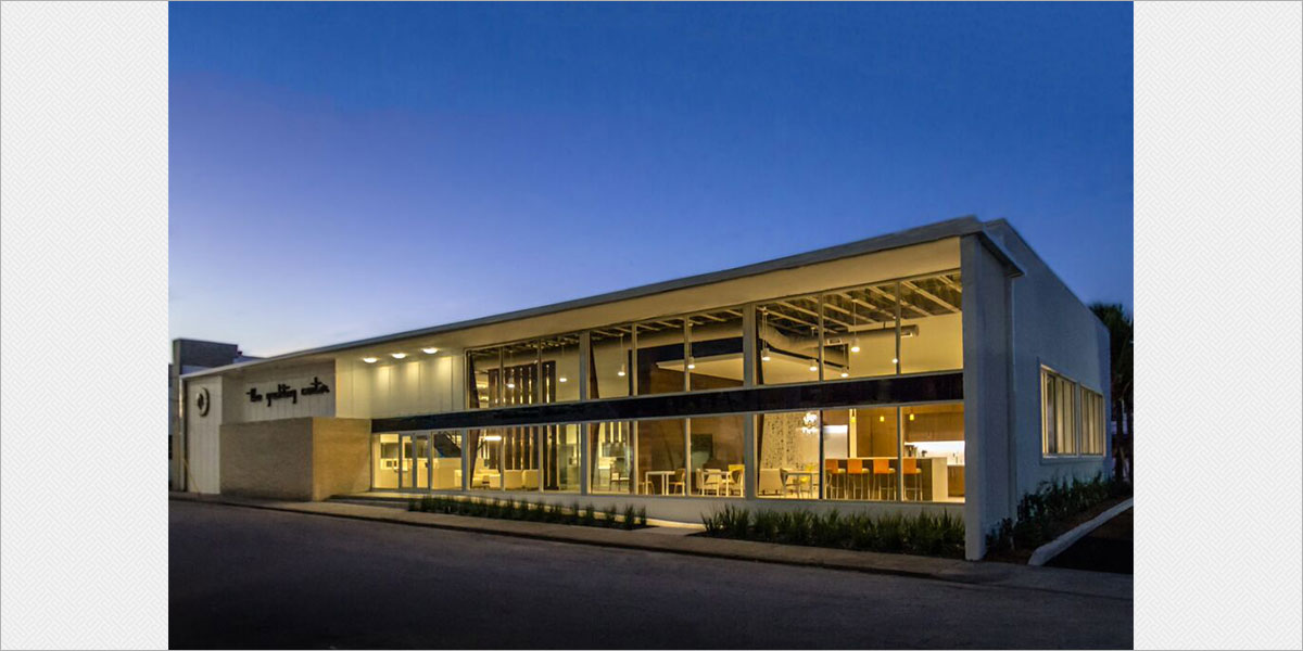 Street view of the office with Oxygen Celena outdoor ceiling mounted fixtures illuminating the entrance.